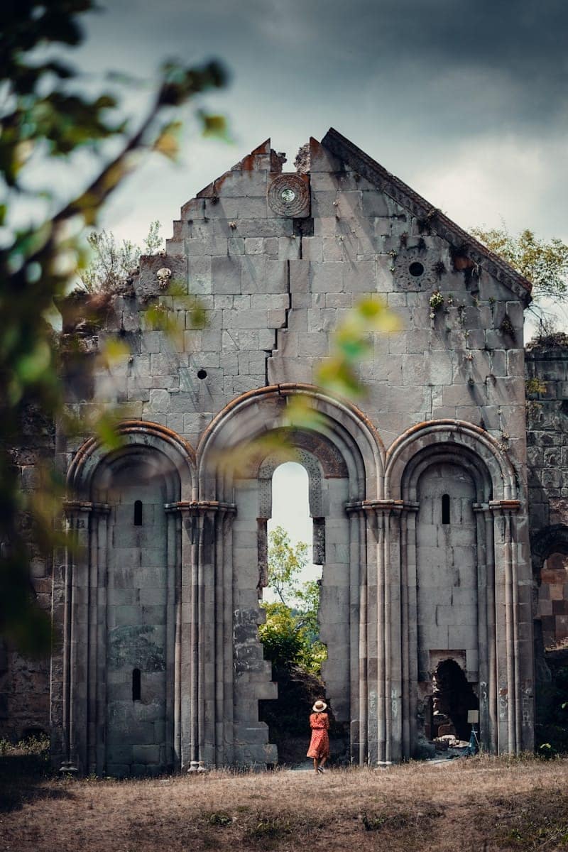 a child standing in front of a broken church