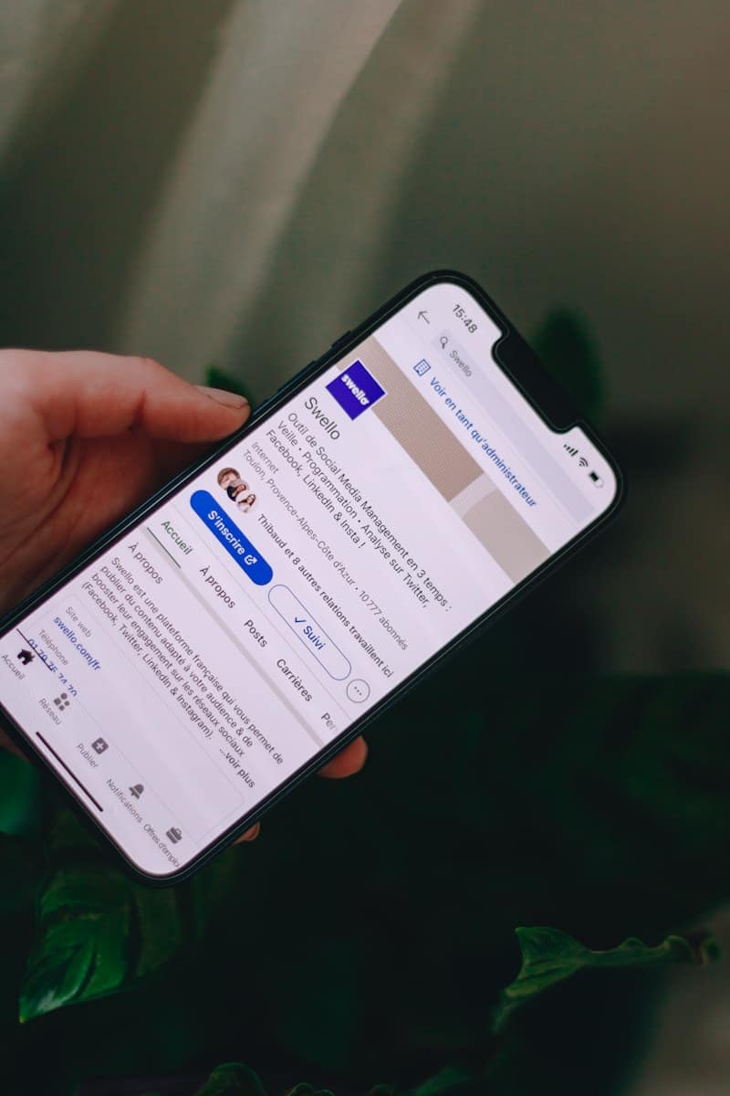 A person browsing LinkedIn on their phone, representing real life tarot applications like career reflection and decision making.