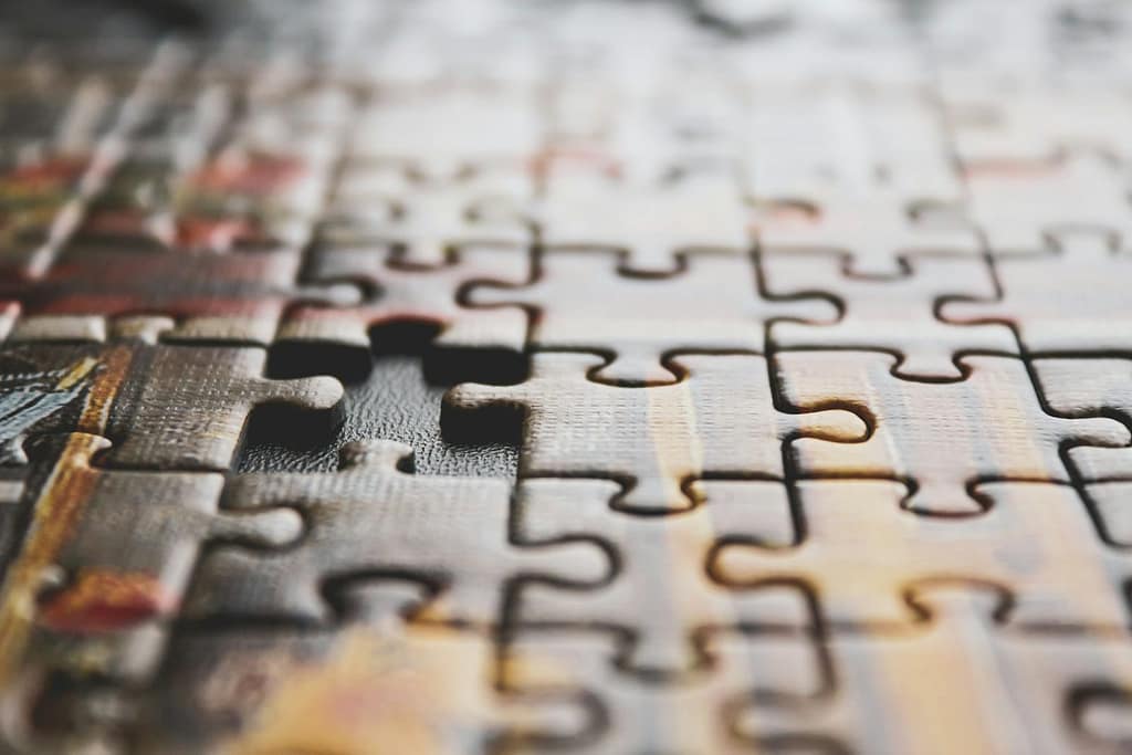 A close-up of a jigsaw puzzle with a missing piece, symbolising how combining tarot with the Enneagram can reveal what’s been missing in self-understanding.