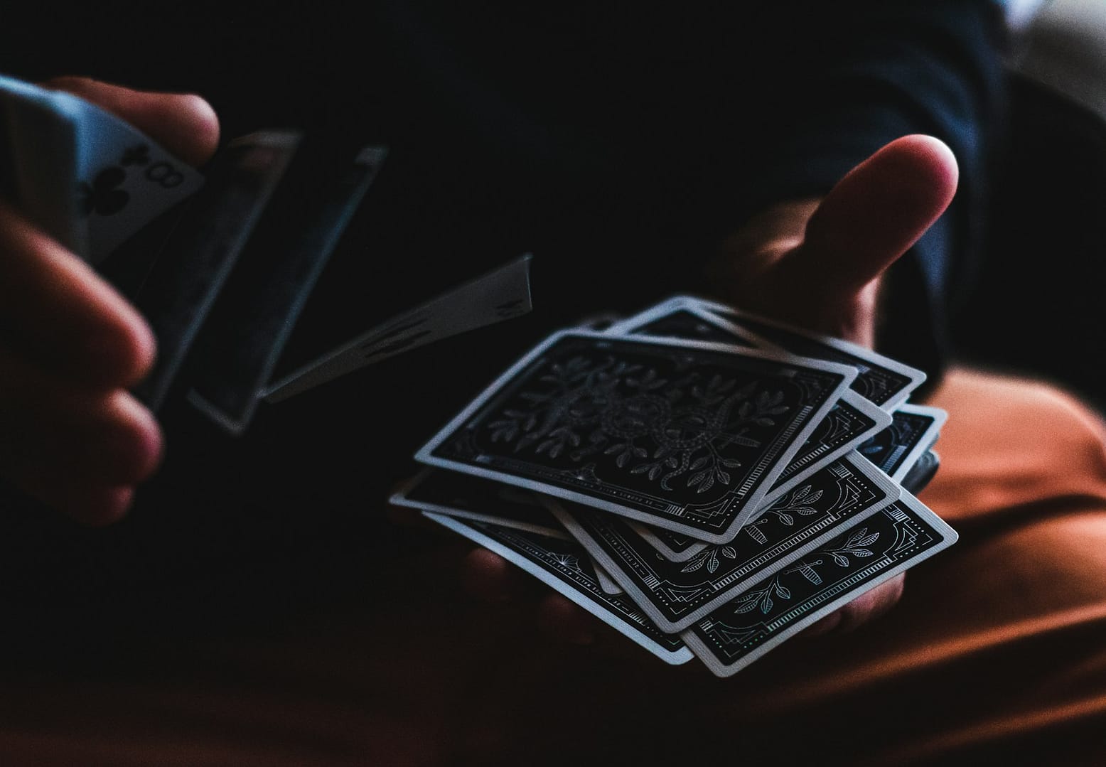 person shuffling tarot cards