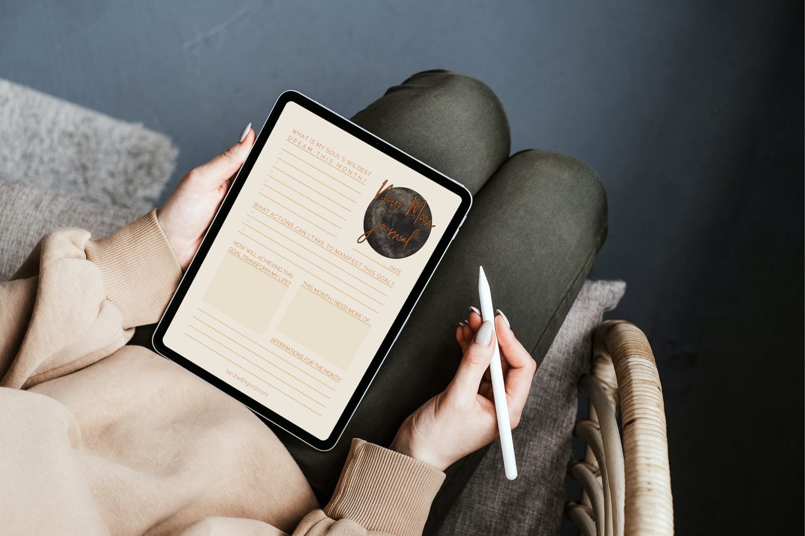 Somebody filling out the New Moon digital journal using an iPad with an Apple Pencil.
