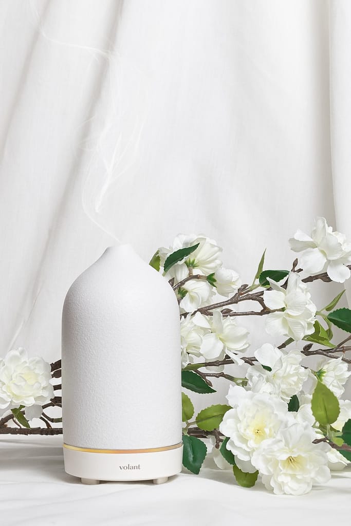 Ceramic diffuser with floral backdrop used to create a calm space for an online tarot reading