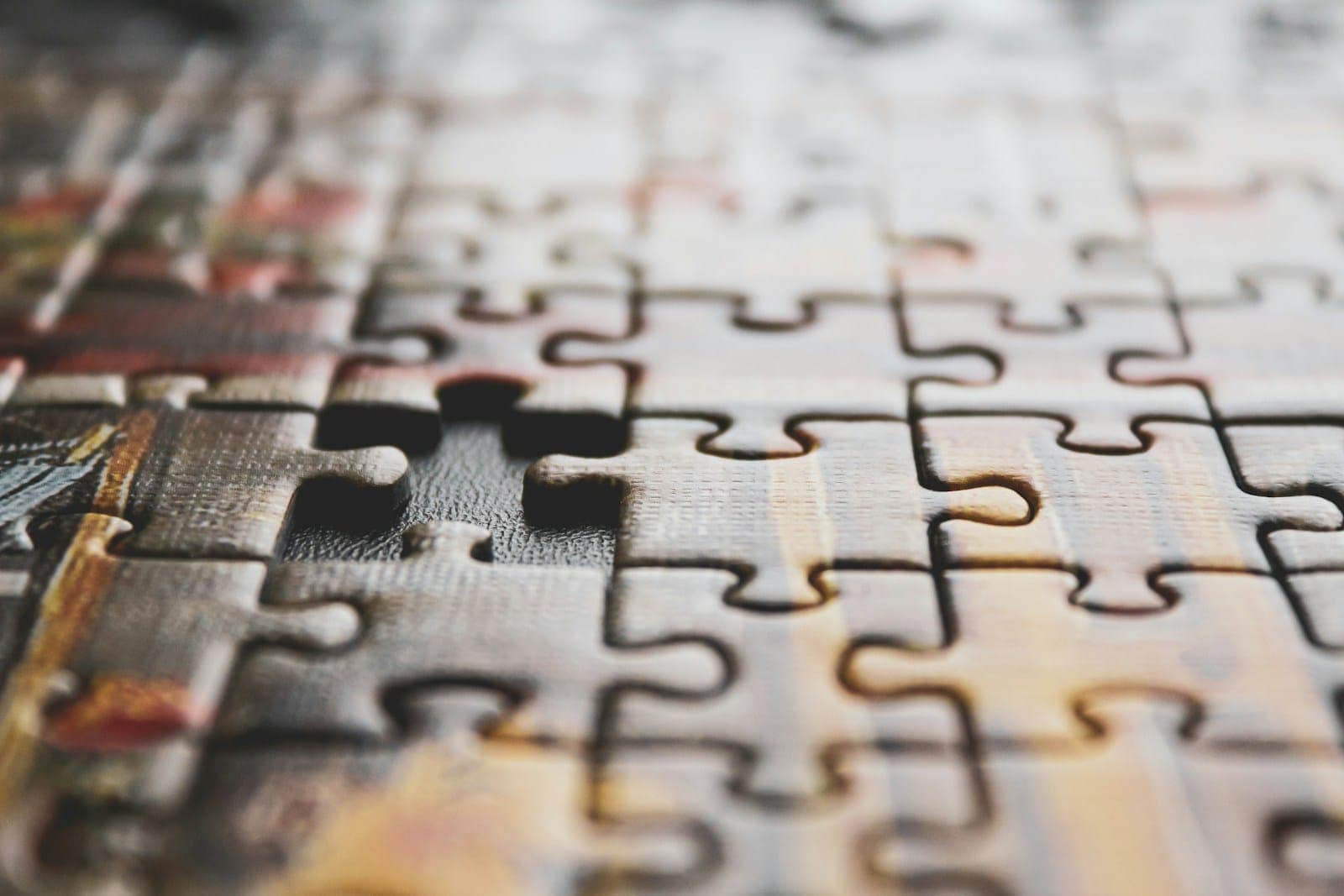 A close-up of a jigsaw puzzle with a missing piece, symbolising how combining tarot with the Enneagram can reveal what’s been missing in self-understanding.