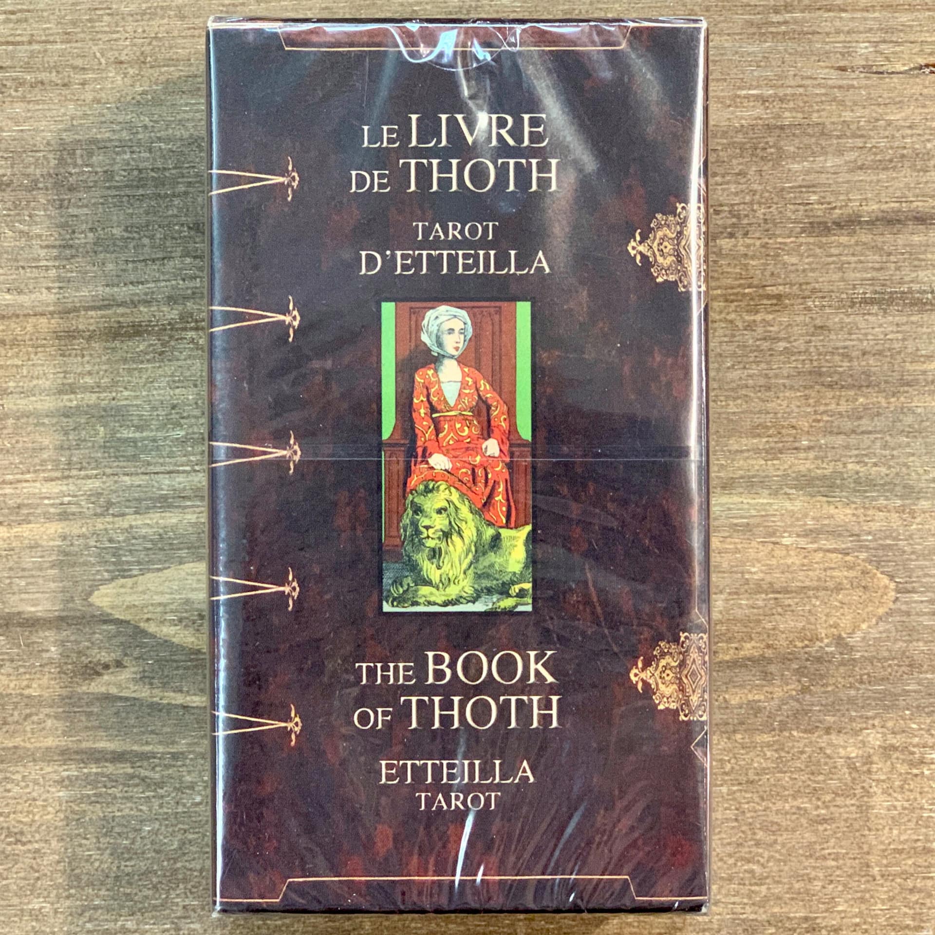 Box of the Book of Thoth Etteilla Tarot deck, showing the title in French and English with a central image of a seated woman and a lion, symbolising its esoteric design.