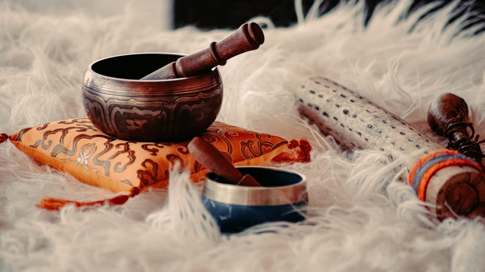 brown wooden mortar and pestle on white textile, what are the benefits of a sound bath