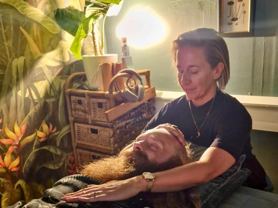 The author of this post receiving some reiki, wondering to themself, is reiki a massage?